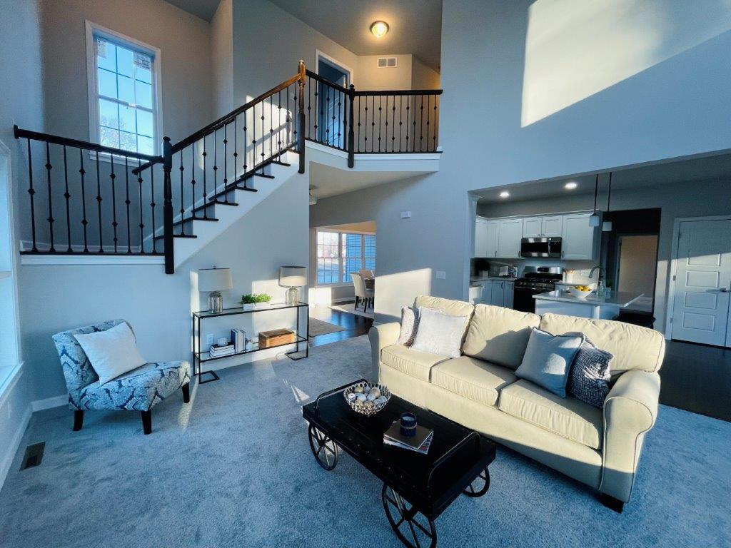 living room with stairs and black stringers
