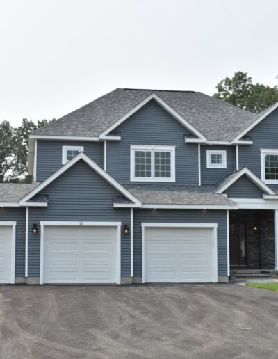 Exterior of blue colonial with 3 car garage