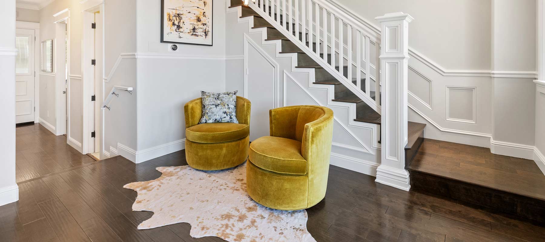 two yellow chairs in a home's entryway