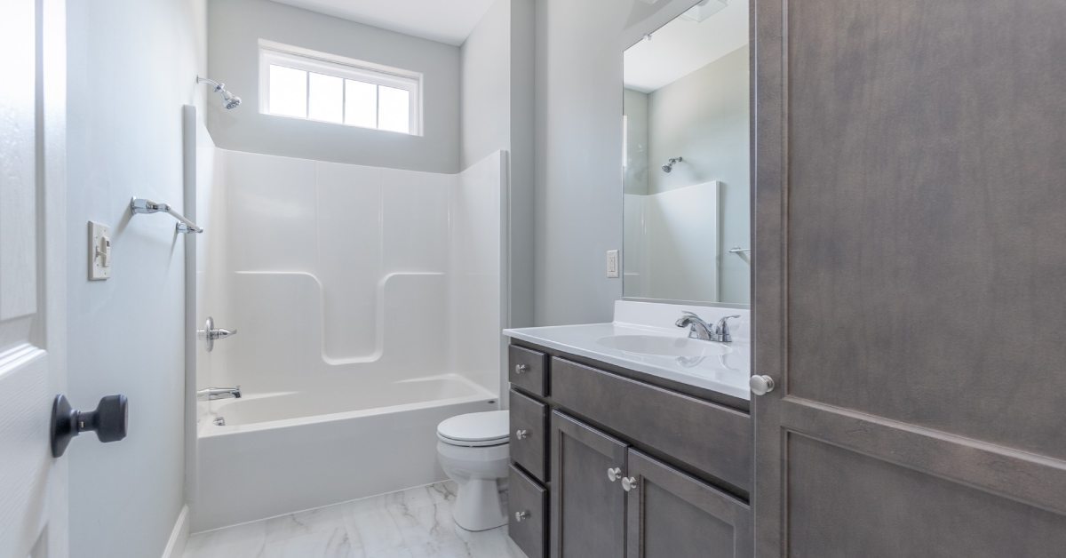 large bathroom with a sink and vanity, toilet, and tub
